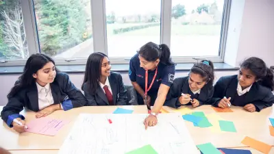  A Bosch UK STEM ambassador helping the students with their presentation.